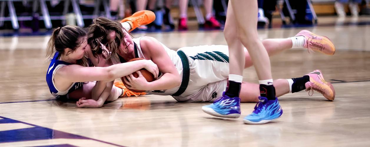 Hopkinton’s Sydney Westover (right) battles Winnisquam forward Bella Sargent during the second half at Bow High School during the D-III semi-finals on Wednesday, February 21, 2024.