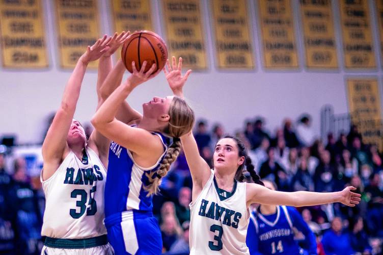Hopkinton players Sydney Westover (35) and Shaylee Murdough (3) surround Winnisquam forward Lauren MacDonald during the second half at Bow High School during the D-III semi-finals on Wednesday, February 21, 2024.