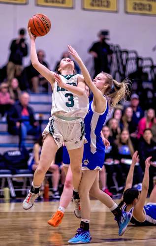 Hopkinton guard Shaylee Murdough (3) goes up for a shot against Winnisquam forward Triniti Carter during the first half at Bow High School during the D-III semi-finals on Wednesday, February 21, 2024.