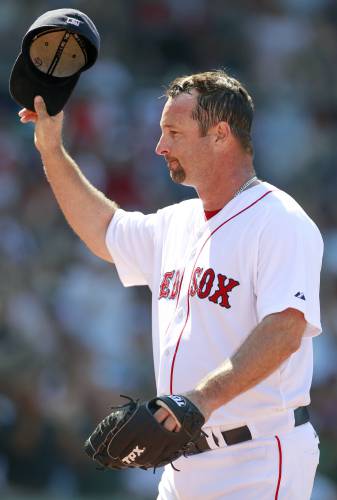 FILE - Boston Red Sox's Tim Wakefield tips his cap as he comes off the field in the sixth inning of a baseball game against the Seattle Mariners in Boston, July 24, 2011. Wakefield, the knuckleballing workhorse of the Red Sox pitching staff who bounced back after giving up a season-ending home run to the Yankees in the 2003 playoffs to help Boston win its curse-busting World Series title the following year, has died. He was 57. The Red Sox announced his death in a statement Sunday,...