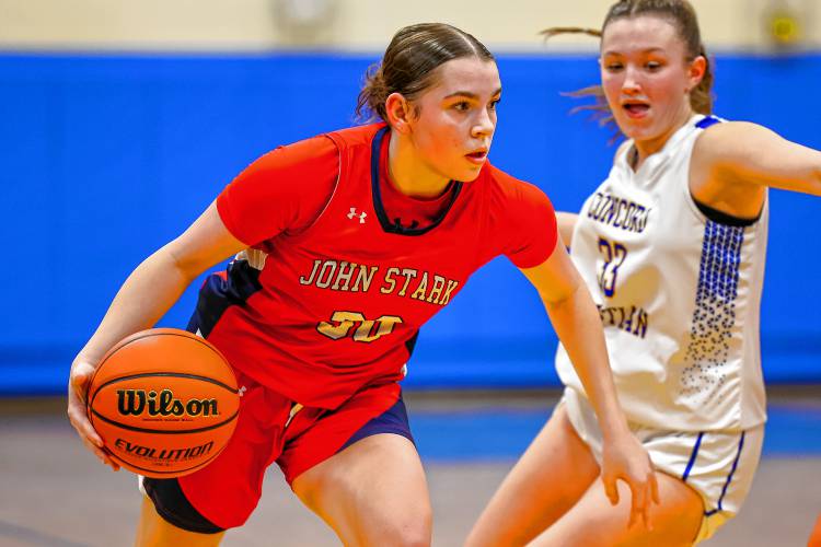 John Stark senior Abby Duclos dribbles to the basket during the D-II semifinal at Salem High School on March 6, 2024.