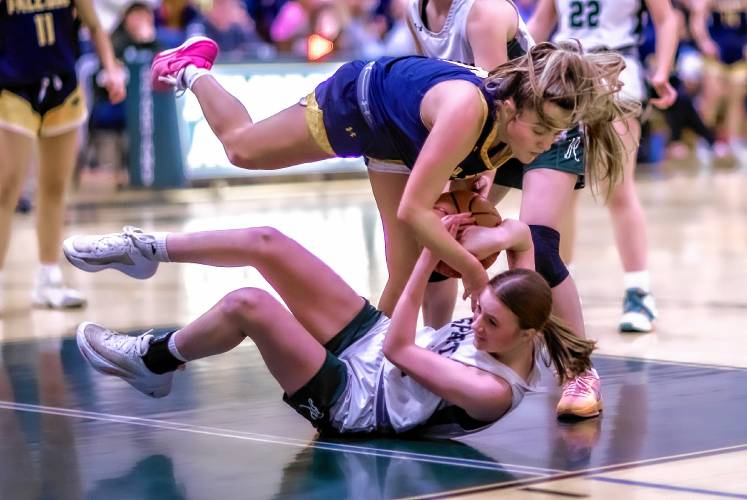 Bow guard Ella Trefethen (top) and Pembroke guard Kate Stephens fall over trying to chase down a loose basketball.