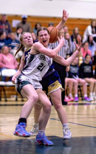 Pembroke forward Annelise Dexter (21) gets tangled up with Bow guard Bryana Szepan trying to secure a rebound during the second half of Saturday’s Division II quarterfinal.