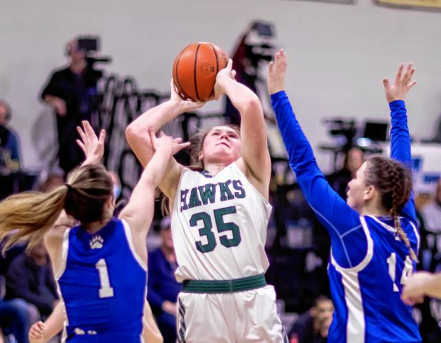 Hopkinton center Sydney Westover shoots over two Winnisquam defenders during the first half of the a Division III girls’ basketball semifinal at Bow High School on Wednesday.
