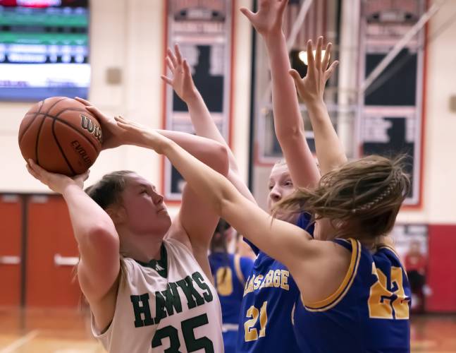 Hopkinton center Sydney Westover goes up to shoot against a group of Kearsarge players during the first half on Saturday night, February 24, 2024 at Keene State College during the D-III Championship game.
