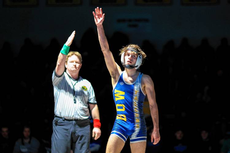 Bow’s Adler Moura raises his hand in celebration after defeating Plymouth’s Anthony Torres in the 113-pound finals at the Division III wrestling championship at Bow High School on Saturday. Moura won his third D-III title and was named the tournament’s Outstanding Wrestler.
