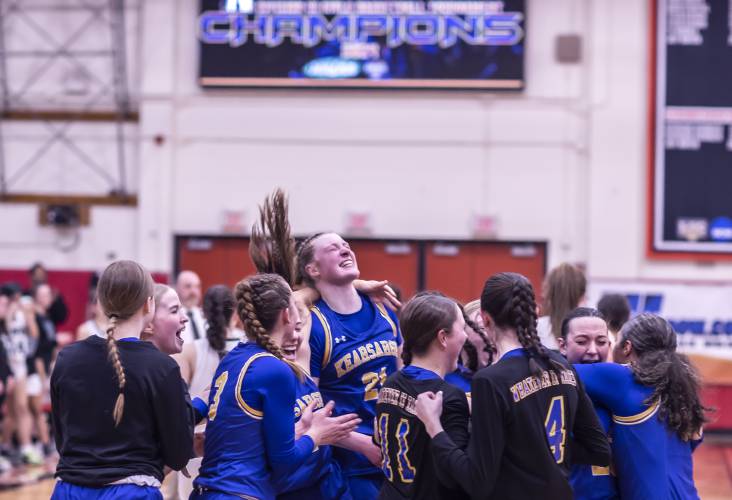 The Kearsarge girls basketball team celebrate at midcourt after they defeated the Hopkinton Hawks to win the Division III championship on Saturday night, February 24, 2024 at Keene State College.