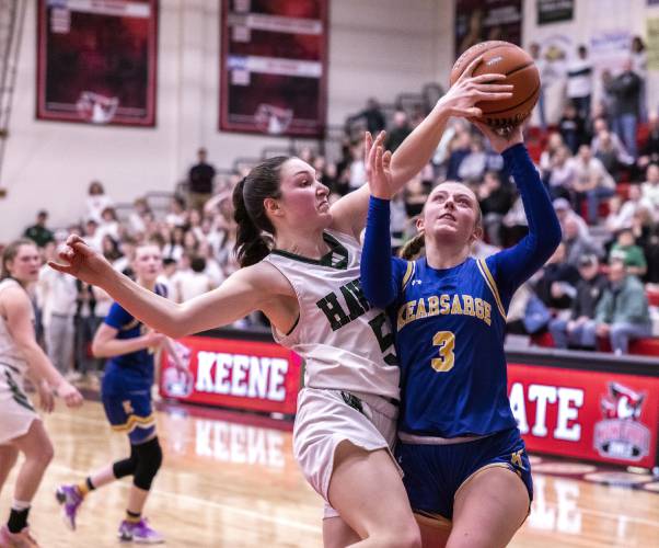 Kearsarge forward Ociee Ilg goes up against Hopkinton guard Paige Boudette in the second half on Saturday night, February 24, 2024 at Keene State College during the D-III Championship game.
