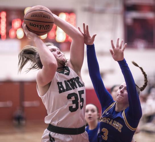 Hopkinton center Sydney Westover goes up to shoot against Kearsarge forward Ociee Ilg during the first half on Saturday night, February 24, 2024 at Keene State College during the D-III Championship game.
