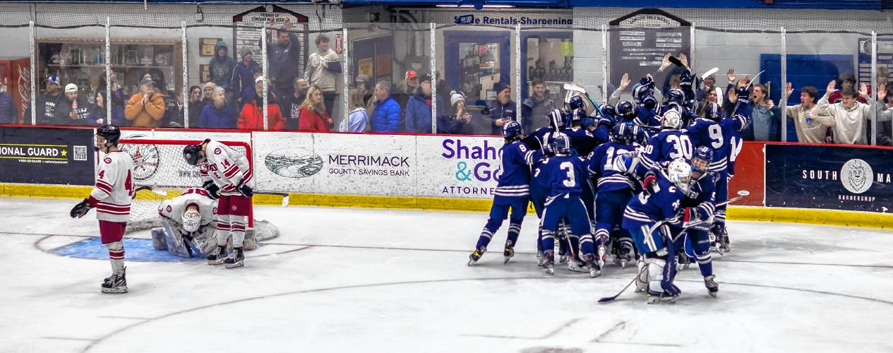 The Exeter hockey team celebrates after scoring the game-winning goal in a 4-3 overtime victory in the Division I quarterfinals at Everett Arena on Saturday night.