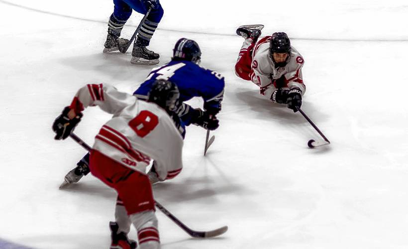 Concord leftwinger Cam Chandonnet (right) stretches out to secure the puck during the second period against Exeter on Saturday, March 2, 2024.