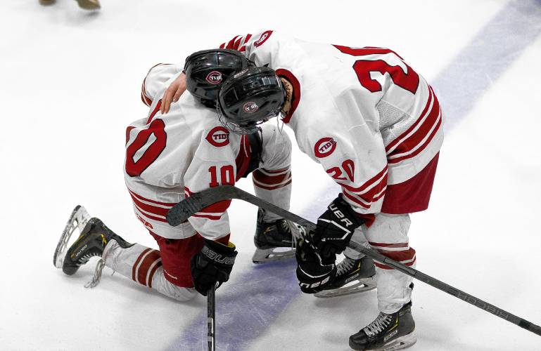 Trevor Craigue (right) consoles Concord teammate Dawson Fancher after the Tide was defeated by Exeter in overtime, 4-3, on Saturday in the quarterfinals.