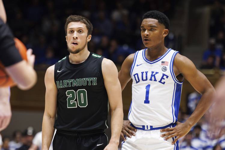 FILE - Dartmouth's Romeo Myrthil (20) stands next to Duke's Caleb Foster (1) during the second half of an NCAA college basketball game in Durham, N.C., Monday, Nov. 6, 2023. A ruling that gives the Dartmouth basketball team the right to unionize has far-reaching implications for all of college sports — from the quaint, academically oriented Ivy League to the big-money football factories like Michigan and Alabama. But it’s not time to cut down the nets just yet. (AP Photo/Ben...