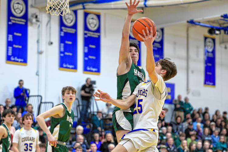 Hopkinton’s Noah Aframe attempts to block a layup from Kearsarge’s Drew Huff during Friday night’s Division III quarterfinal.