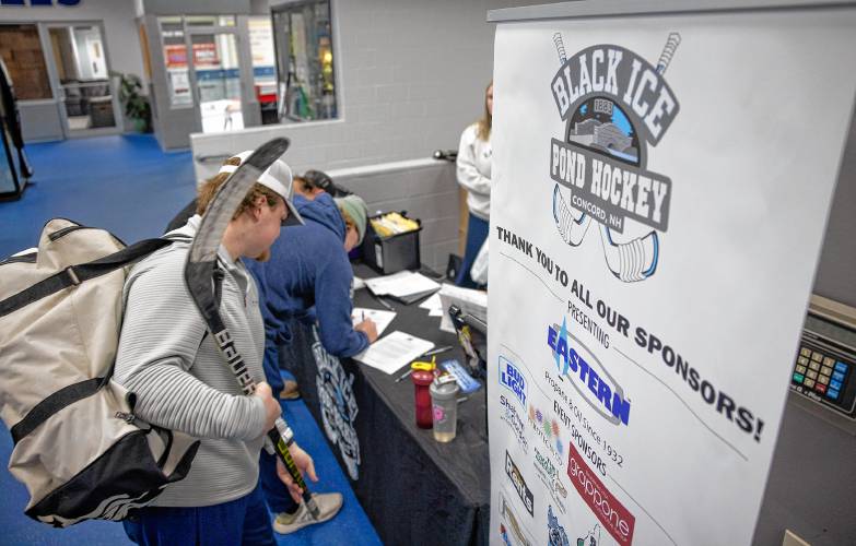 Players check in to the Black Ice Hockey Tournament at the Tri-Town Arena in Hooksett on Friday, March 22, 2024.