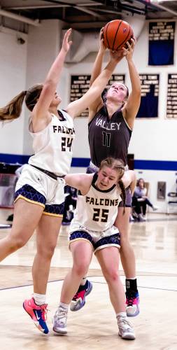 Bow guard Bryana Szepan tries to block out Merrimack Valley forward Kayla Smith as Bow forward Kathryn McGovern trys to corral a rebound during the second half on Wednesday, February 28, 2024.