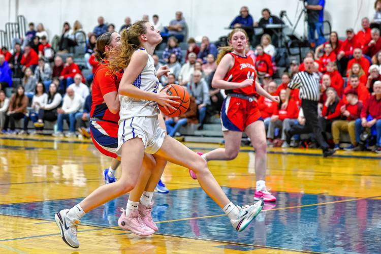 Emma Smith races to the hoop during the Division II semifinal against John Stark on March 6. Smith led the Kingsmen with 27 points in the 68-50 win.