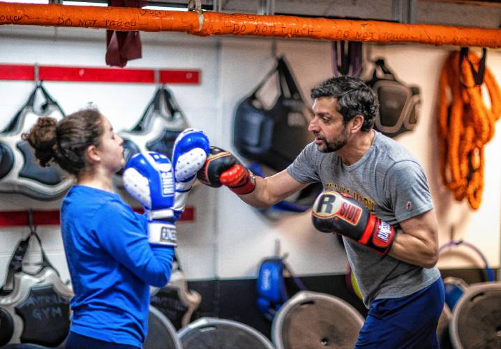 Ada Sansone warms up for her boxing class with her dad, Ken, at Averill’s in downtown Concord.