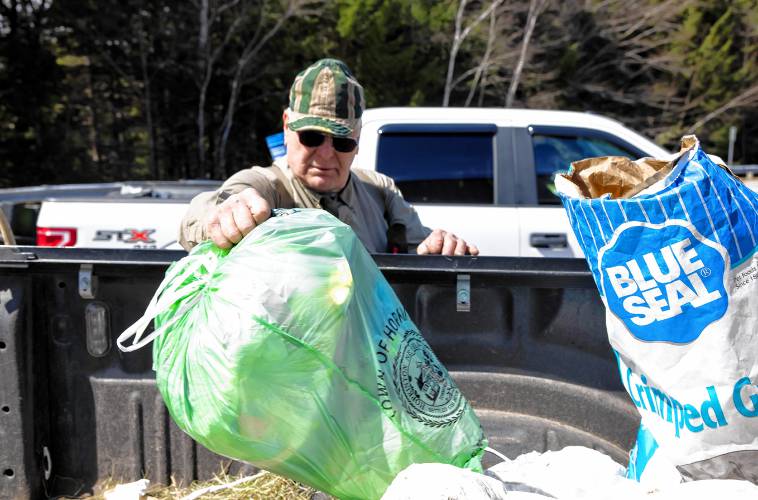 Brad Watson, a resident of Hopkinton for 50 years, empties his green bag for household items along with his agricultural waste items at the Hopkinton Transfer Station on Wednesday morning, April 17, 2024. Watson is not a fan of the green bags.