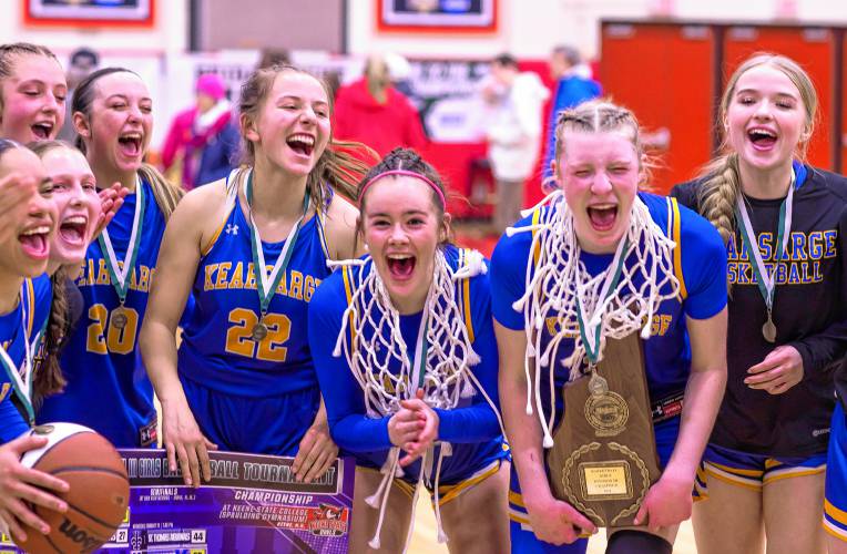 Ava Shapiro (center with net), Tessa Marinello (holding plaque) lead the celebration of the Kearsarge girls team after they defeated the Hopkinton Hawks to win the Division III championship on Saturday night, February 24, 2024 at Keene State College.