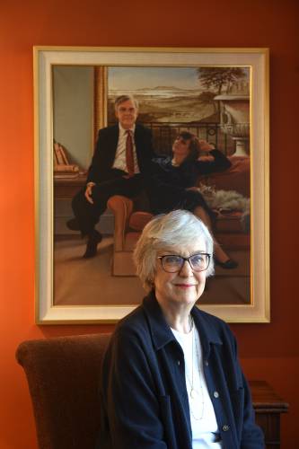 Susan Gillotti, of Hanover, has become an advocate for the proposed New Hampshire aid in dying bill. Behind Gillotti is a portrait of her and her husband.