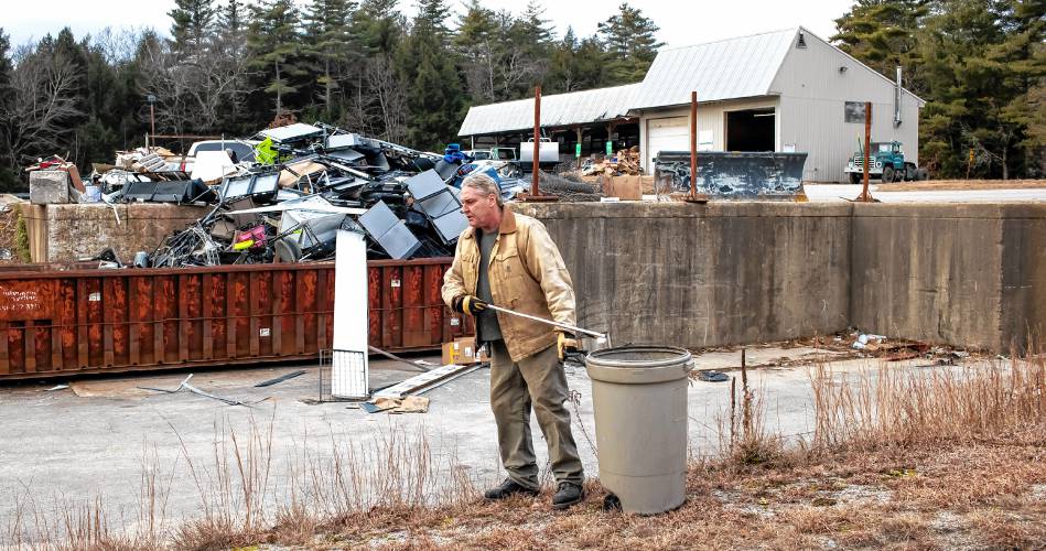 Hopkinton Webster Transfer Station employee Ted Valley picks up trash along the service road in front of the recycling center on Wednsday, January 3, 2024.