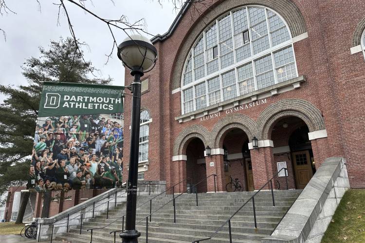A Dartmouth Athletics banner hangs outside Alumni Gymnasium on the Dartmouth College campus in Hanover on Tuesday.