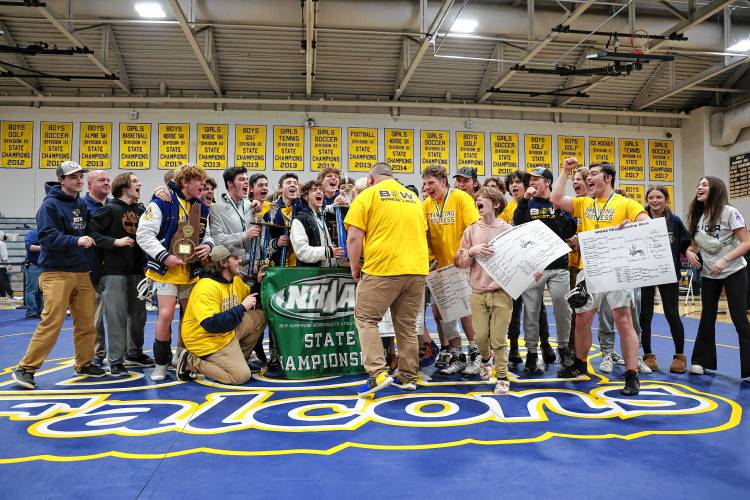 The Bow Falcons celebrate their Division III wrestling championship win at Bow High School on Sat. Feb. 17, 2024.