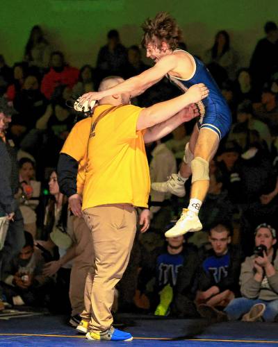 Bow senior Adler Moura celebrates with coach Bill Chavanelle after winning the 113-pound championship on Saturday, Feb. 17, 2024.