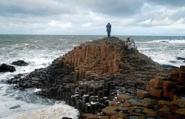Tourists visit the Giants Causeway on the Antrim Coast, in northern Ireland.