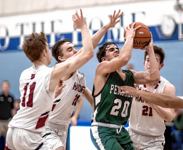Pembroke guard Joe Fitzgerald (20) is surrounded by four Hanover players as he attempts to go to the basket during the second half of a Division II semifinal game at Oyster River High School on Tuesday night.