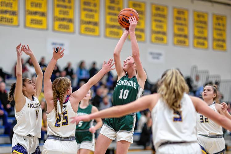 Pembroke sophomore Kate Stephens shoots over Bow’s Bryana Szepan (25) and Gabriella Tarsa (11) during the Spartans’ win on Jan. 2. Both teams are headed to the D-II girls’ basketball tournament.