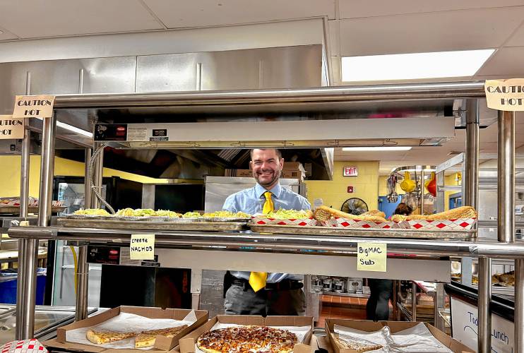 Incoming Bow High School principal Matt Fisk serves students lunch last week.