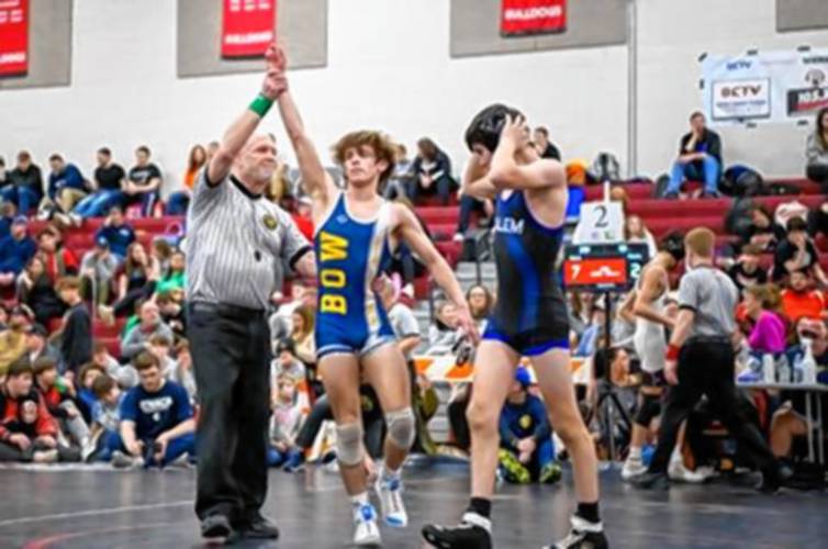 The referee declares Bow’s Adler Moura (center) the winner at the end of the 113-pound championship bout at the NHIAA wrestling Meet of Champions on Saturday. Moura defeated Salem’s Dominic Murphy in a 7-2 decision to claim his first MOC title.