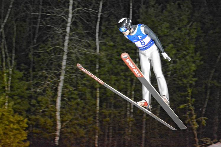 Merrimack Valley's Mychal Reynolds flies through the air at the NHIAA ski jumping state championship at Chip Henry Ski Jump in Conway on Thursday, Feb. 15, 2024. Reynolds was the top area jumpers, placing third in the state. MV finished fourth as a team. JOSHUA SPAULDING / Salmon Press