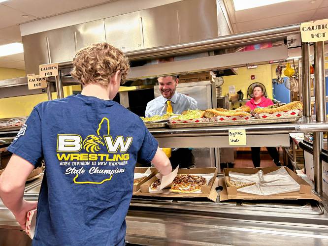 Incoming Bow High School principal Matt Fisk serves students lunch on Wednesday, April 17.