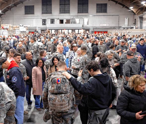 Members of the New Hampshire Army National Guard  3rd Battalion, 197th Field Artillery Regiment, back from 10-month deployment to the Middle East  greet their familites on their arrival at the Manchester Armory on Thursday night, February 8, 2024.