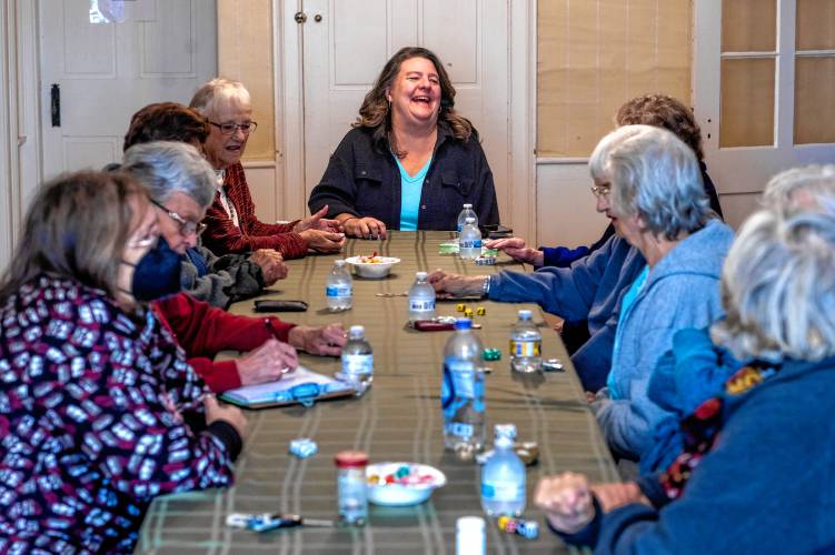 Former intergenerational outreach coordinator Kristen Pinard-Kenney,  center, laughs with the women from the senior center who have known each other for more than 20 years as they play a dice game at the Penacook Historical Society on Thursday.