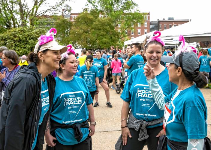 Concord Hospital Breast Care Center staff members Kellie Booth (left), practice manager; Dana LeBlanc, medical assistant; Tammy Pillsbury, registered nurse; Rosemarie Padin, medical assistant, wear pink swans so they could find each other during the race.