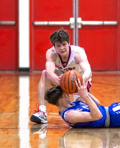 Coe-Brown guard Ryan Kouchoukos tries to steal the basketball from Pelham forward Justin Bowlan during the fourth quarter of their NHIAA Division II game on Tuesday night.