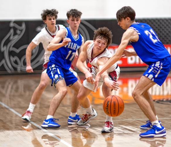 Coe-Brown guard James McKane is surrounded by Pelham players during the fouth quarter on Tuesday, February 18, 2025. Pelham won in overtime.