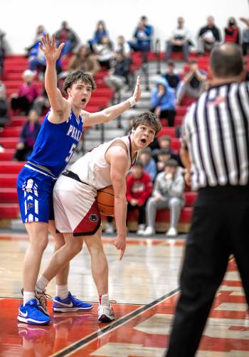 Coe-Brown guard Ryan Kouchoukos (right) and Pelham forward Brady Hegan both argue with the referee about if Kouchoukos had stepped out of bounds during the waning minutes of overtime on Tuesday, February 18, 2025. The ref said he did step out of bounds and Pelham was awarded the ball.