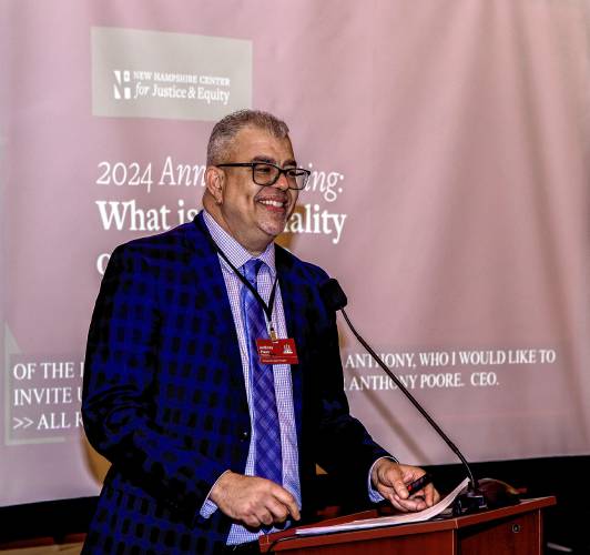 Anthony Poore, President/CEO, NHCJE, speaks at the annual meeting of the New Hampshire Center for Justice and Equity at the Barn at Bull Meadow in Concord on Tuesday.