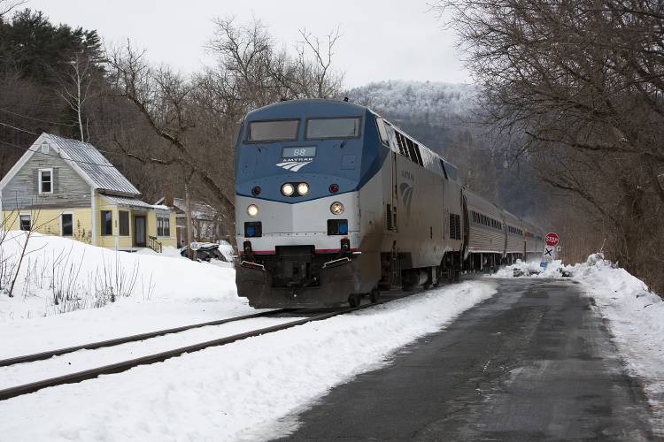 A southbound Amtrak train crosses Acton Place in South Royalton on Wednesday. A 92-year-old Massachusetts woman died after a freight train collided with her car.