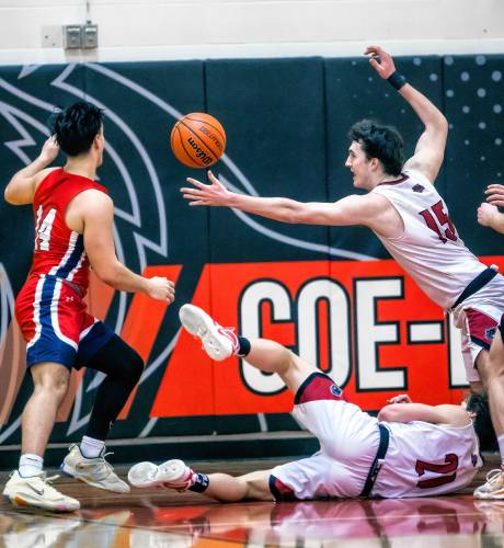 Coe-Brown players Jack Matson (15) and Ryan Kouchoukos (21) try to save the ball in the chaotic last seconds of the game against John Stark on Tuesday, February 6, 2024. Coe-Brown went on to win, 61-53 in overtime.