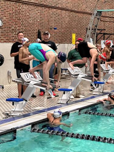 Concord’s Lily Peterson gets set in the blocks before competing in the 100-yard breaststroke at the NHIAA Division I championship at the University of New Hampshire’s Swasey Pool on Saturday. Peterson finished second in the event.