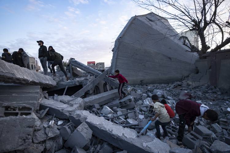 Palestinians look at a mosque destroyed in an Israeli strike in Rafah, Gaza Strip, Wednesday, Jan. 24.