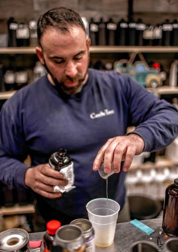 Ross Mingarelli pours to create scents for his speciality candles at is downtown Candle Tree Soy Candle shop. Mingarelli has over 600 different scents for his candles.
