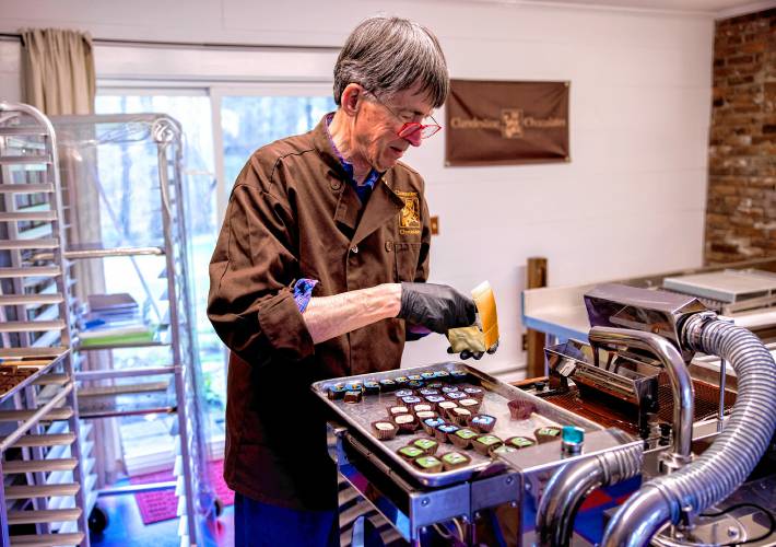 Chocolatier Jonathan Doherty packs up a collection of chocolates in a packing box at his home in Hopkinton on Wendesday, April 30, 2024.