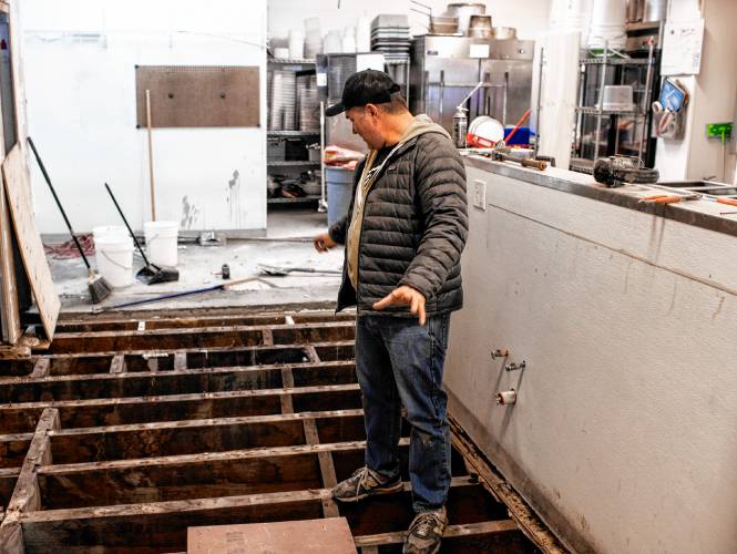 Dos Amigos owner Joel Harris shows the floor of the kitchen that needed to be replaced at the Main Street restaurant in downtown Concord on Tuesday, February 6, 2024. Harris hopes to re-open sometime next week.